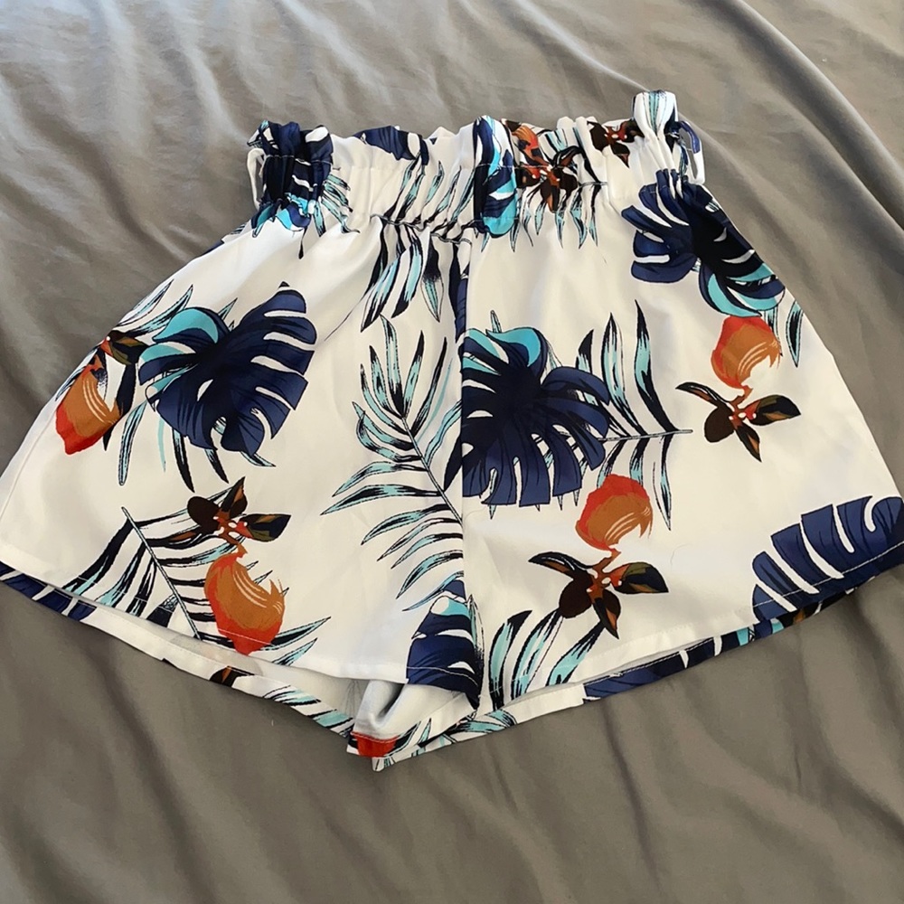 White silky shorts with a blue leafy design